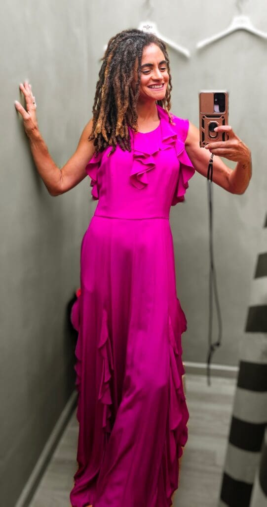 woman tries on hot pink silk gown