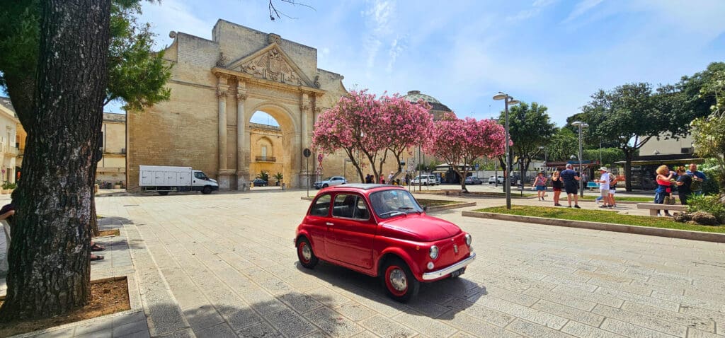 red fiat on stone driveway 
