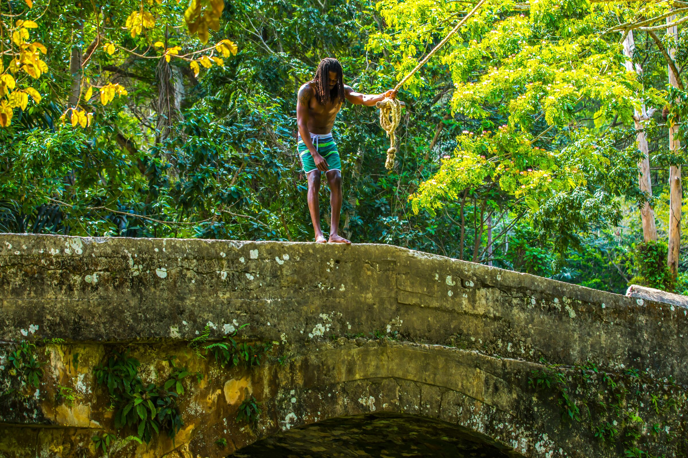 Man prepares to rope jump from Spanish Bridge in St. Ann Jamaica