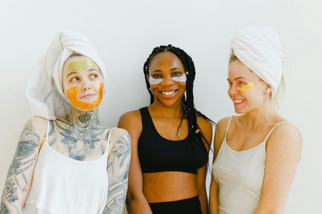 3 women in face mask and hair towels