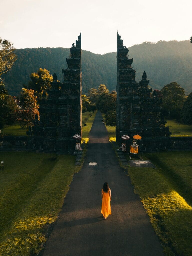 A woman walking towards the iconic Handara Gate in Bali, Indonesia