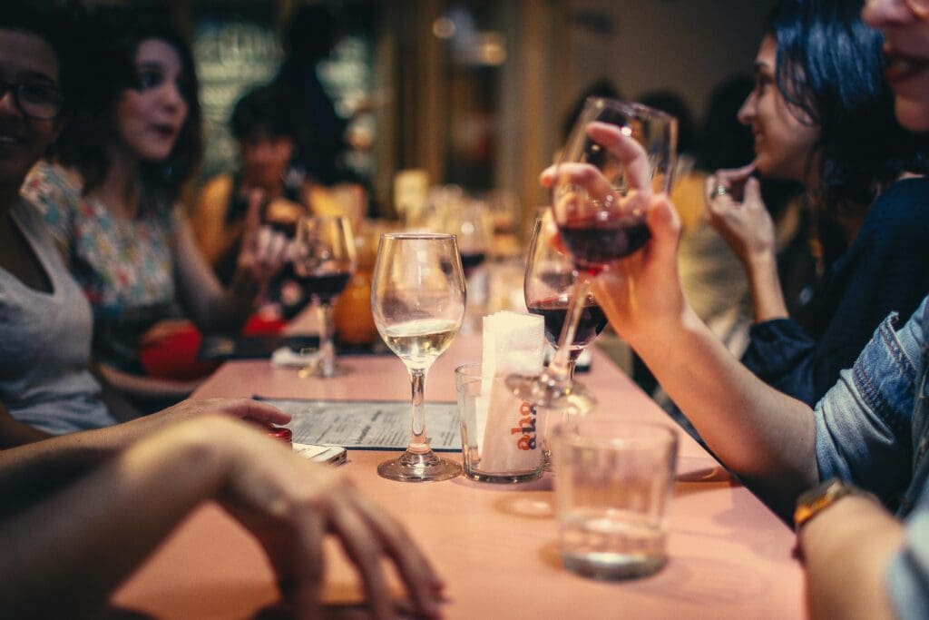 table of friends with wine glasses
