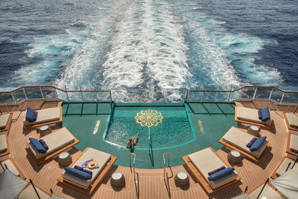 semi-circular pool with day beds all around off the stern of the Explora II yacht style floating boutique hotel.