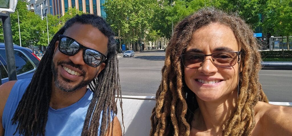 man and woman smile into the camera from Tuk Tuk in madrid