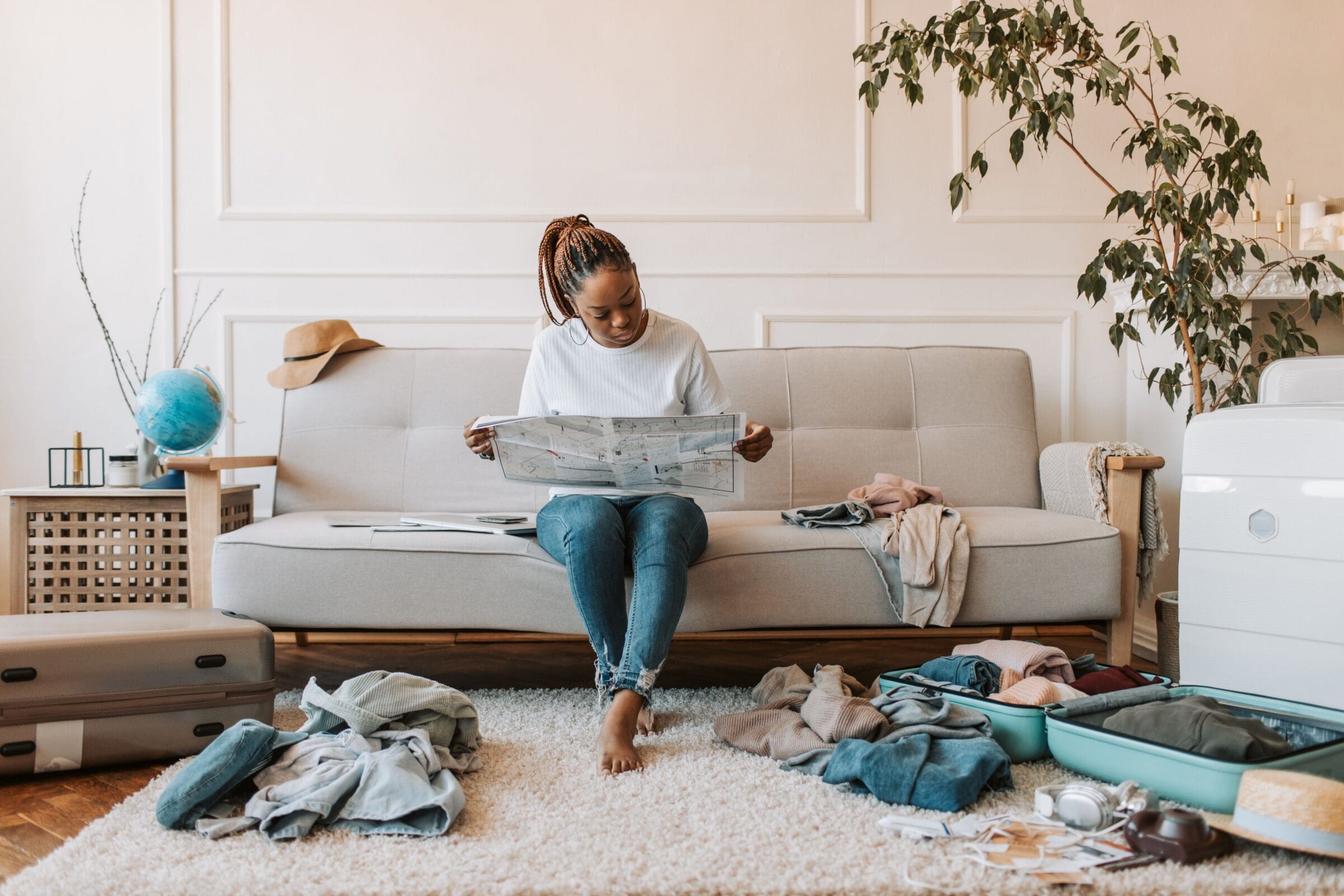 woman with map on couch. Why you shouldn't always plan your own trip
