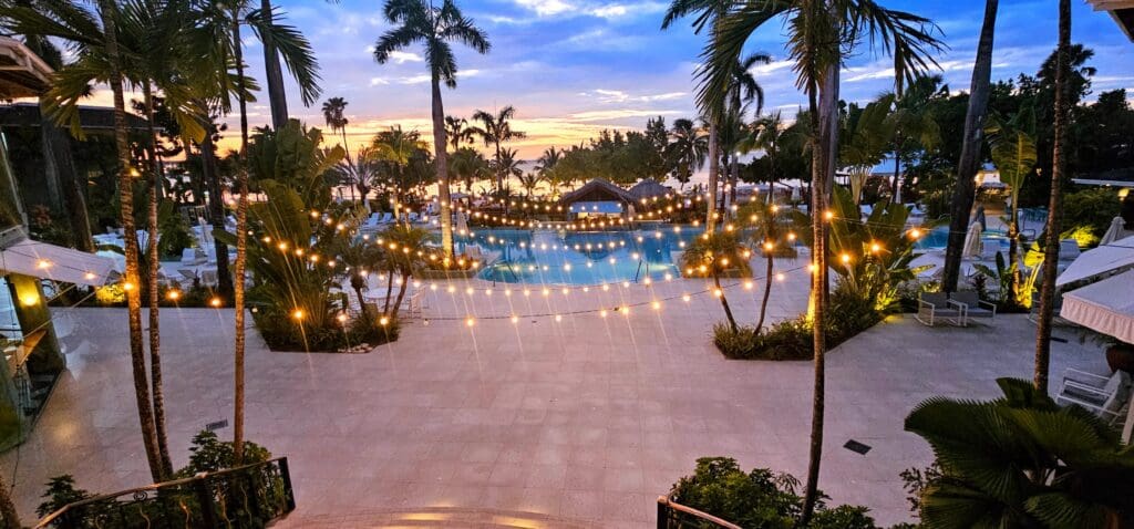 Twinkle lights over a pool with Palm trees at Couples Negril Jamaica