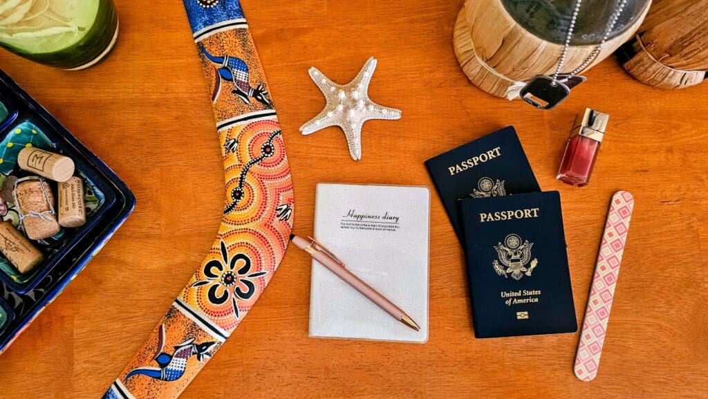 Happiness diary, passports and a pen on a wooden table 